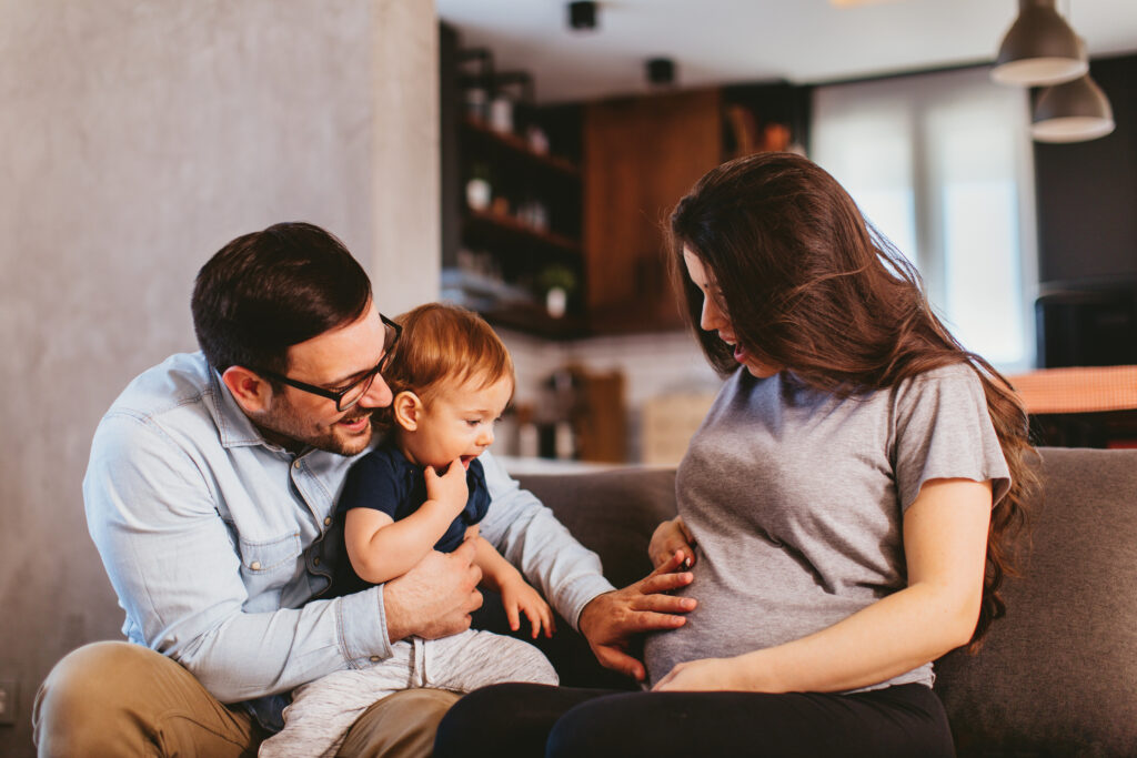 Happy family at home excited about expecting new baby