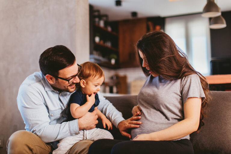 Happy family at home excited about expecting new baby