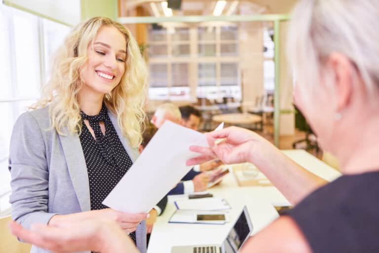 Young woman as a student or trainee is happy to receive a certificate after passing the exam